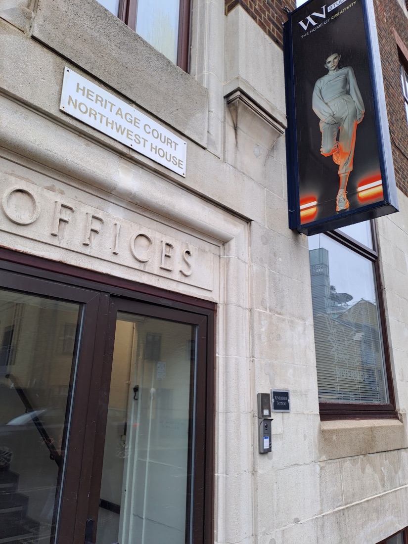 The entrance to Riverside Tattoo at Heritage Court, Northwest House, with the studio nameplate and buzzer on Sampson Street, Wapping